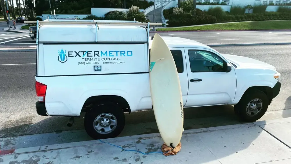 ExterMetro pest control truck on a coastal route day in Huntington Beach